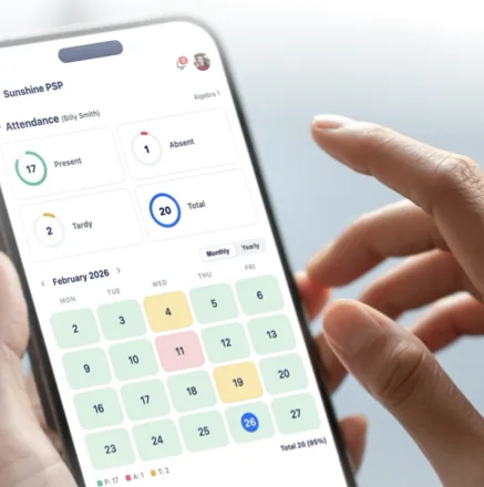 A phone showing a student's monthly attendance calendar